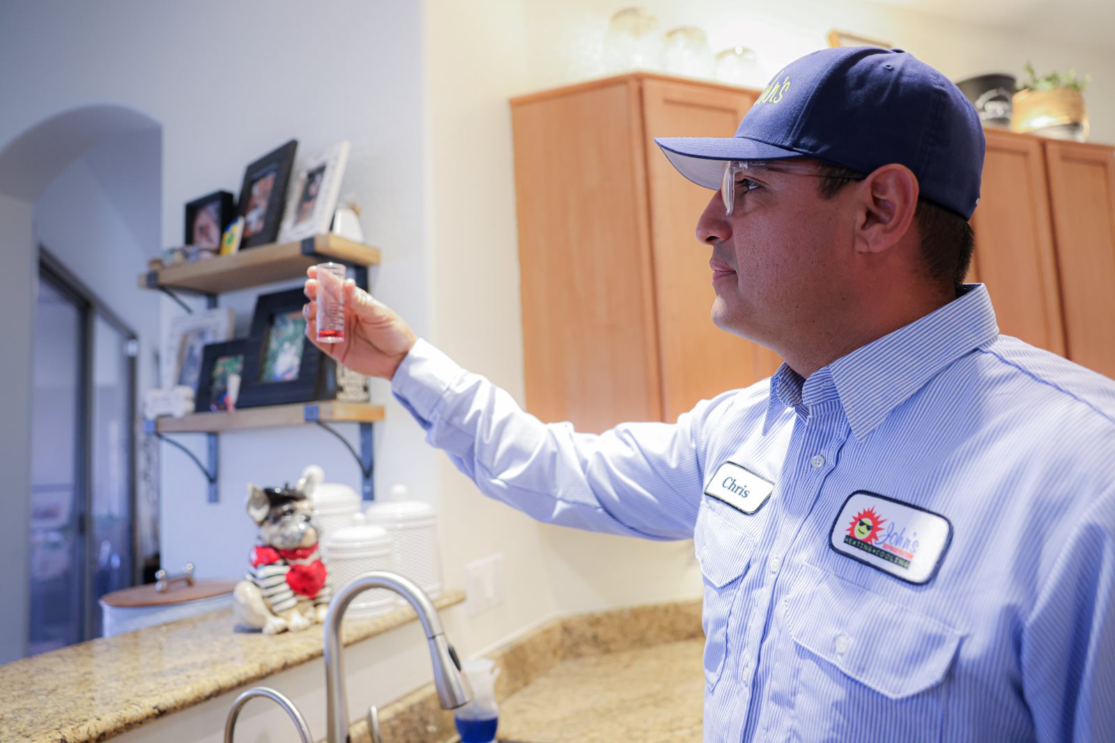A John’s technician inspecting a water sample in Mesa
